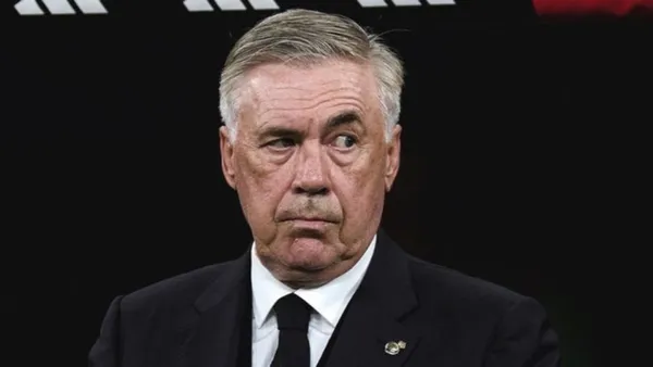 Carlo Ancelotti looks serious while wearing the suit.