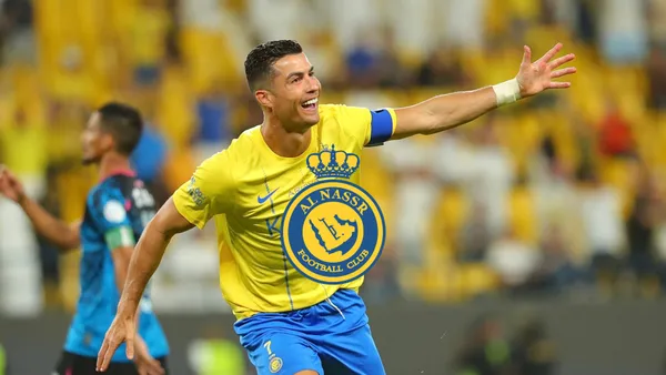 Cristiano Ronaldo celebrates his Al Nassr goal with his arm out while wearing the Al Nassr jersey.