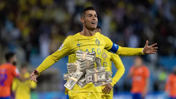 Cristiano Ronaldo celebrates his goal with Al Nassr while a stack of money is in the middle. (Source: GOATTWORLD)