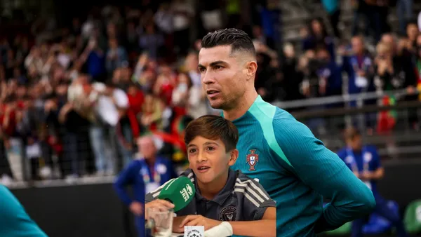 Cristiano Ronaldo looks at the pitch while wearing the Portugal training kit and Thiago Messi is speaking with a microphone.