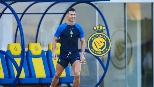 Cristiano Ronaldo wears an Al Nassr training kit while the Al Nassr badge is next to him.