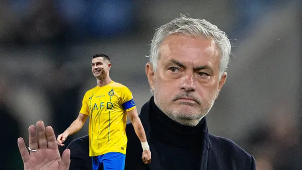 Jose Mourinho puts his hand up with a serious face and Cristiano Ronaldo smiles while wearing an Al Nassr jersey.