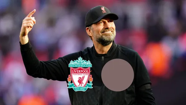 Jurgen Klopp smiles at the Liverpool fans in the stadium.