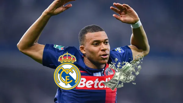 Kylian Mbappé celebrates a PSG goal with his arms up in the air; below him is the Real Madrid logo and flying bills.