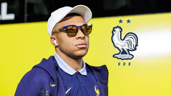 Kylian Mbappé looks serious while wearing sunglasses and the French national team badge is next to him.