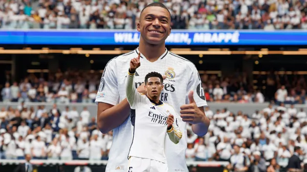 Kylian Mbappé smiles and points at the Real Madrid badge while Jude Bellingham points and holds the Real Madrid badge on his jersey. (Source: Real Madrid, Jude Bellingham X)