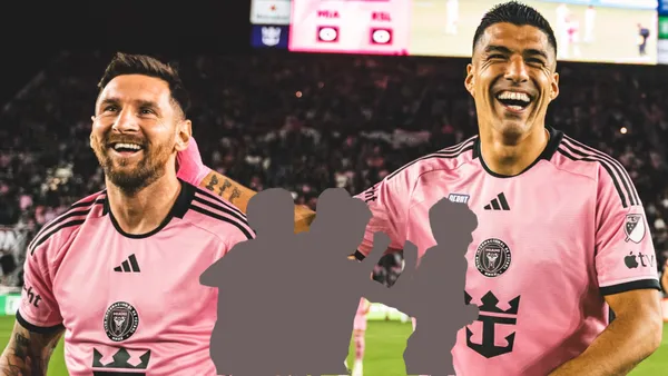 Lionel Messi and Luis Suarez laughing before an Inter Miami match.