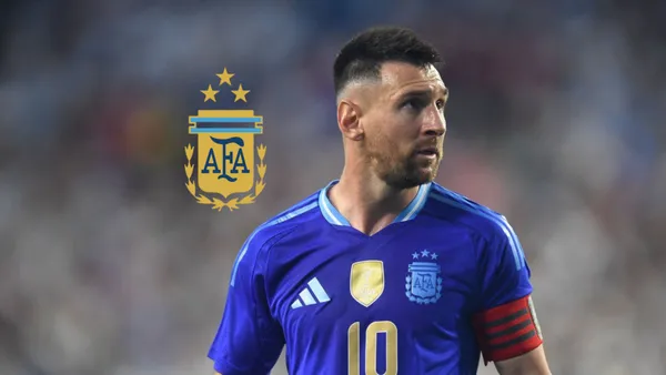 Lionel Messi looks up while wearing the away Argentina jersey and the Argentina national team badge is next to him. (Source: Messi Xtra X)