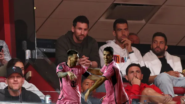 Lionel Messi, Sergio Busquets, and Jordi Alba watching an NBA game in Miami.