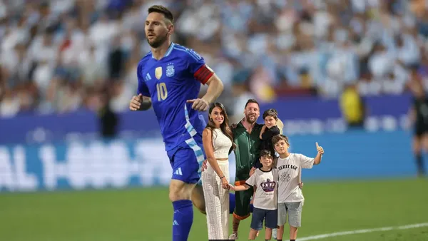 Lionel Messi wears the dark blue Argentina jersey while a picture of Messi and his family is below him.