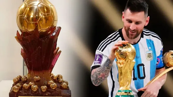 Lionel Messi with the World Cup and the Super Ballon d'Or trophy.