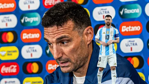 Lionel Scaloni talks in a press conference while Lionel Messi looks focused with an Argentina jersey on. (Source: Messi Xtra X)