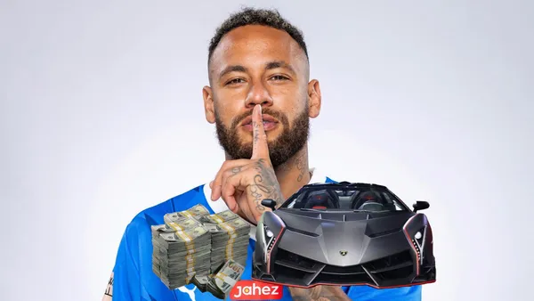 Neymar posing for a picture with an Al Hilal jersey on.