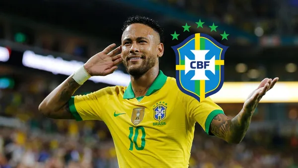 Neymar puts his hand on his ear while wearing the Brazilian national team jersey, the Brazilian national team badge is next to him.