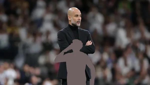 Pep Guardiola focused as the coach of Manchester City.