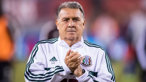Tata Martino claps while wearing the Mexico sweater.