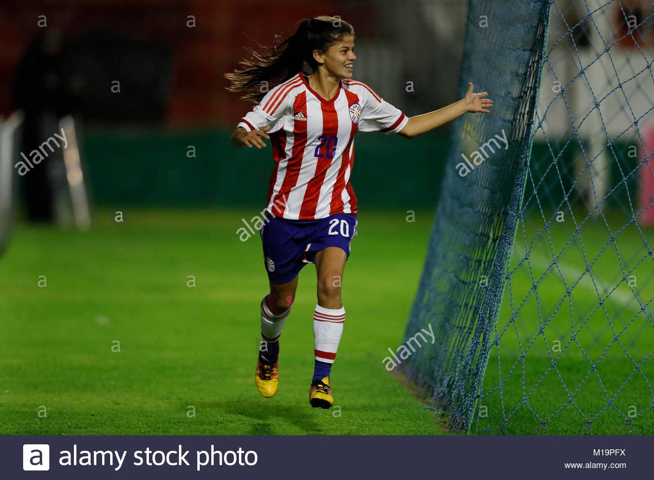 A Paraguayan female footballer receives a set of pots for being the best player of a match in the women's league.