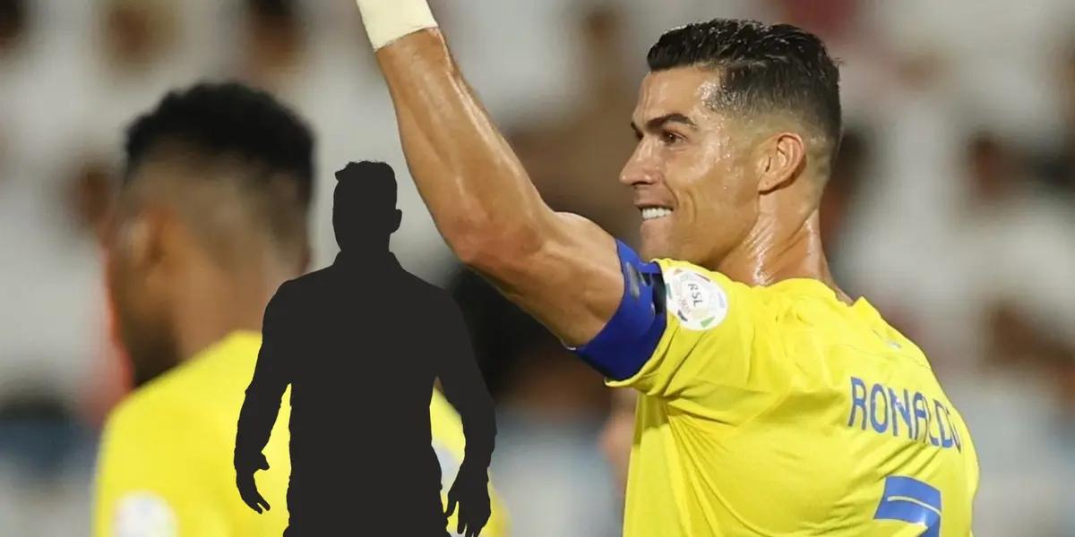 Cristiano Ronaldo celebrates his goal with his arm raised to the crowd in an Al Nassr jersey.