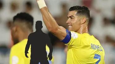 Cristiano Ronaldo celebrates his goal with his arm raised to the crowd in an Al Nassr jersey.