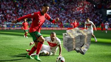 Cristiano Ronaldo looks at the ball with the Portugal jersey on and a stack of cash is next to him. (Source: Cristiano Ronaldo X)