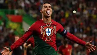 Cristiano Ronaldo sticks his tongue out while wearing the Portugal national team jersey; the Portugal national team logo is in the middle.