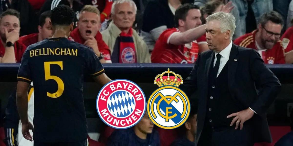 Jude Bellingham walks to the bench and shakes Carlo Ancelotti's hand.