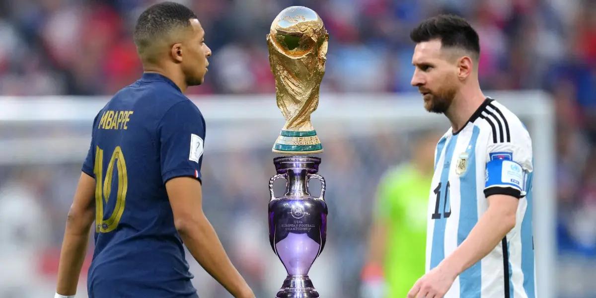 Kylian Mbappé and Lionel Messi looks at each other as the World Cup trophy and the European Championship trophy is in between them.