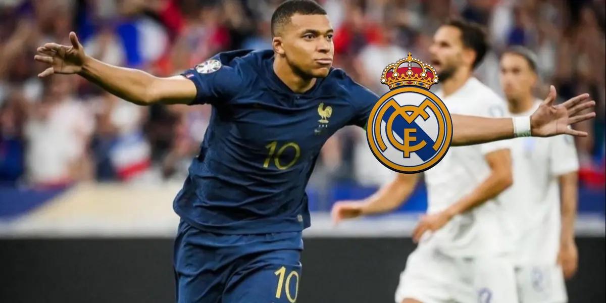 Kylian Mbappé celebrates a France goal with his arms out while wearing the blue France national team jersey; the Real Madrid badge is next to him.