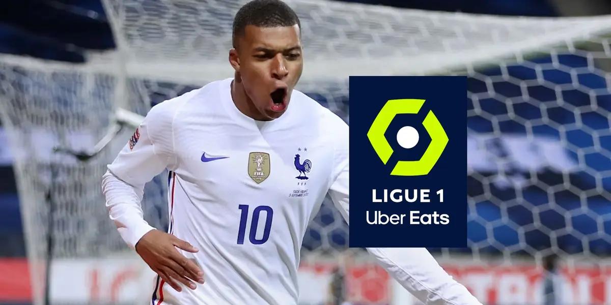Kylian Mbappé celebrates his goal with the French national team and the Ligue 1 logo is next to him.