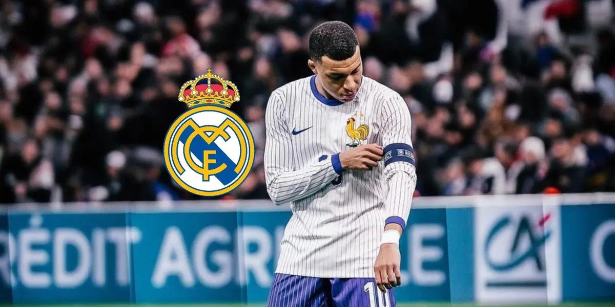 Kylian Mbappé fixes his captain arm band while wearing the France national team jersey and the Real Madrid badge is next to him.