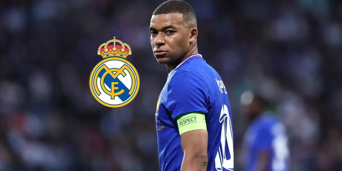Kylian Mbappé looks back while wearing the French national team jersey and the Real Madrid badge is next to him.