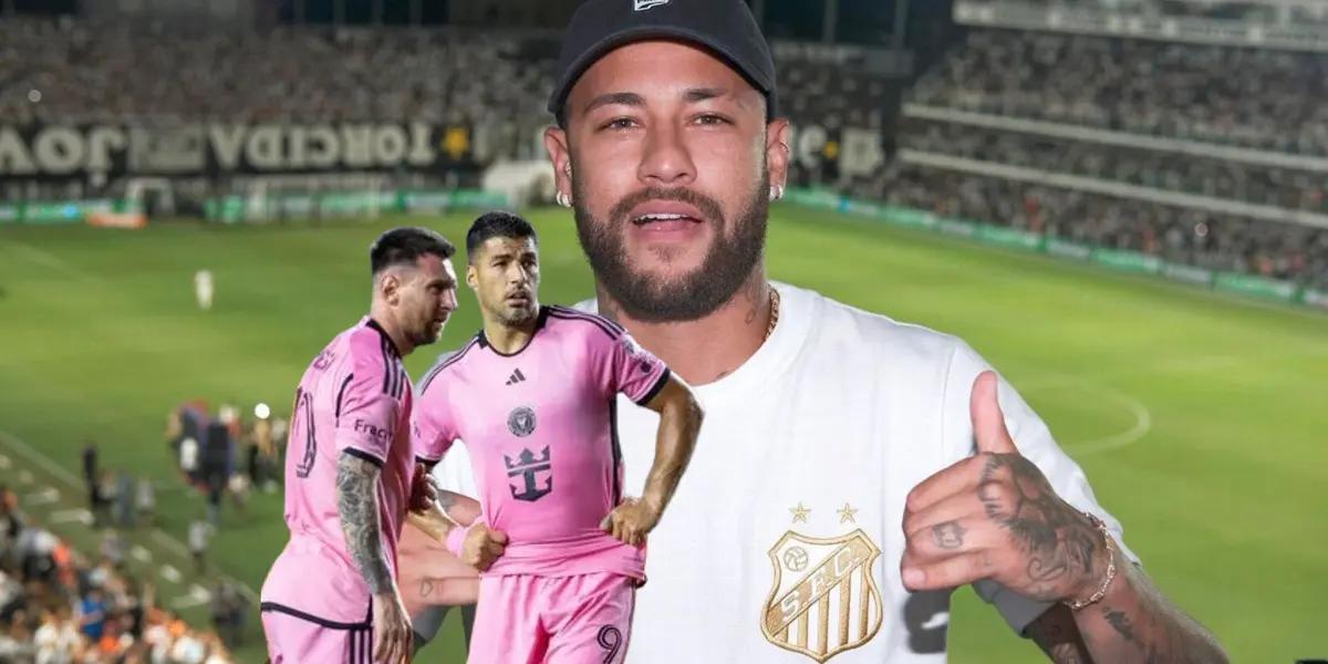 Lionel Messi and Luis Suarez look on to the pitch while Neymar throws a thumbs up with a Santos FC shirt.