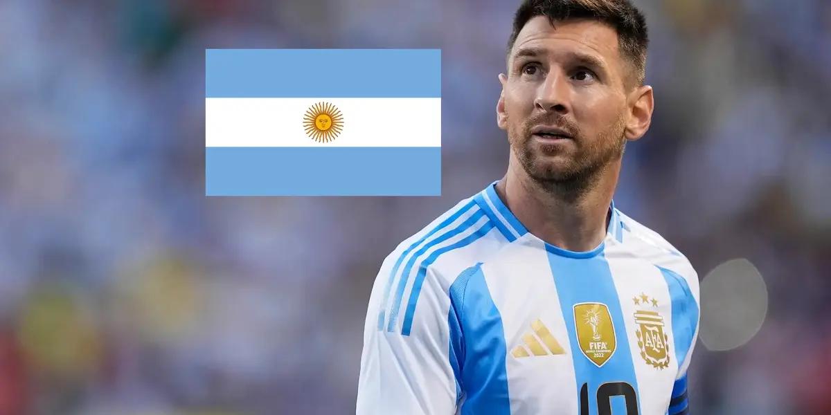 Lionel Messi looks up while wearing an Argentina jersey and the Argentina flag is next to him.