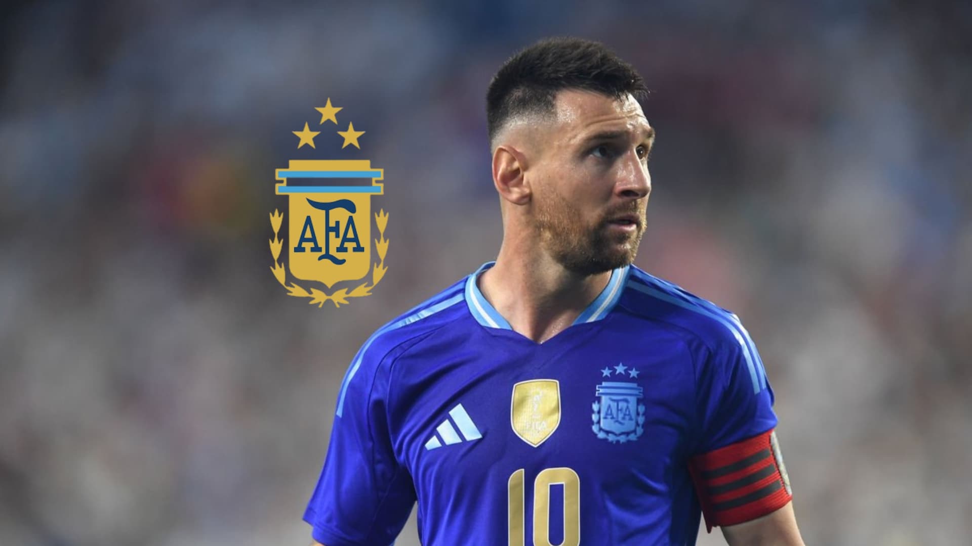 Lionel Messi looks up while wearing the away Argentina jersey and the Argentina national team badge is next to him. (Source: Messi Xtra X)