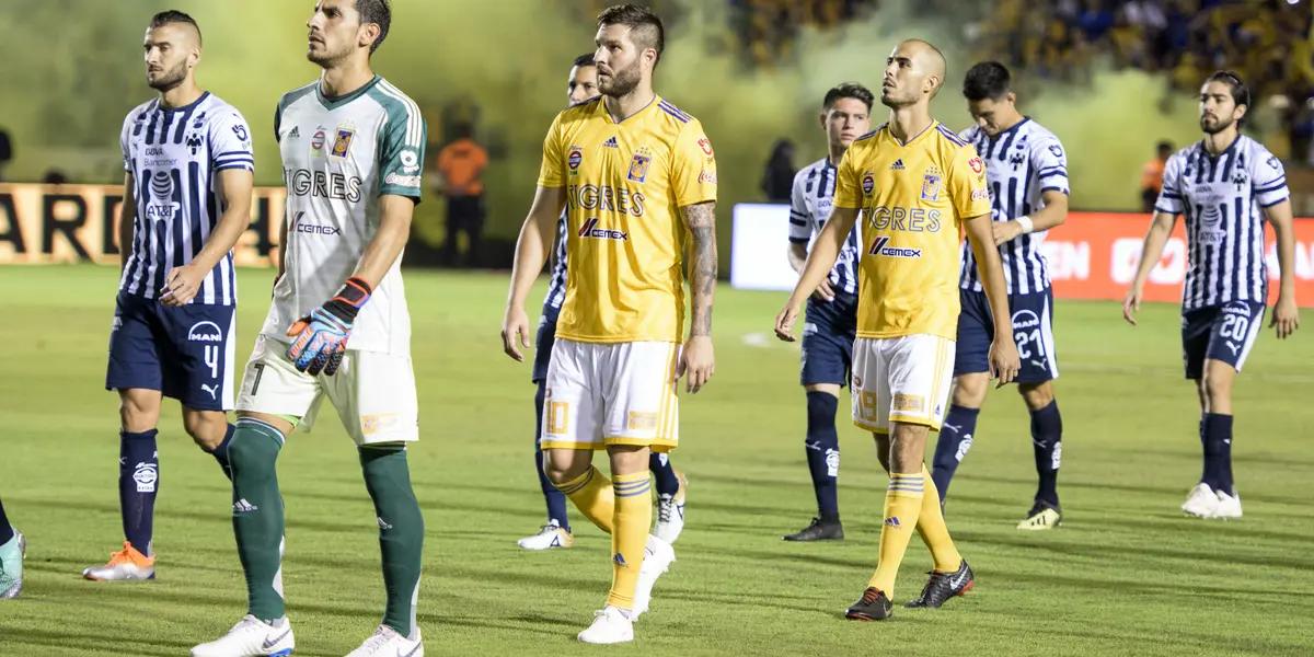 Monterrey and Tigres players talk onto the pitch.