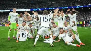 Real Madrid players celebrate on the pitch after advancing to the Champions League final.