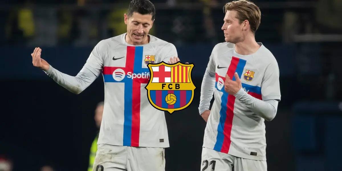 Robert Lewandowski and Frenkie De Jong discuss with one another while wearing FC Barcelona jerseys; the FC Barcelona badge is in the middle.