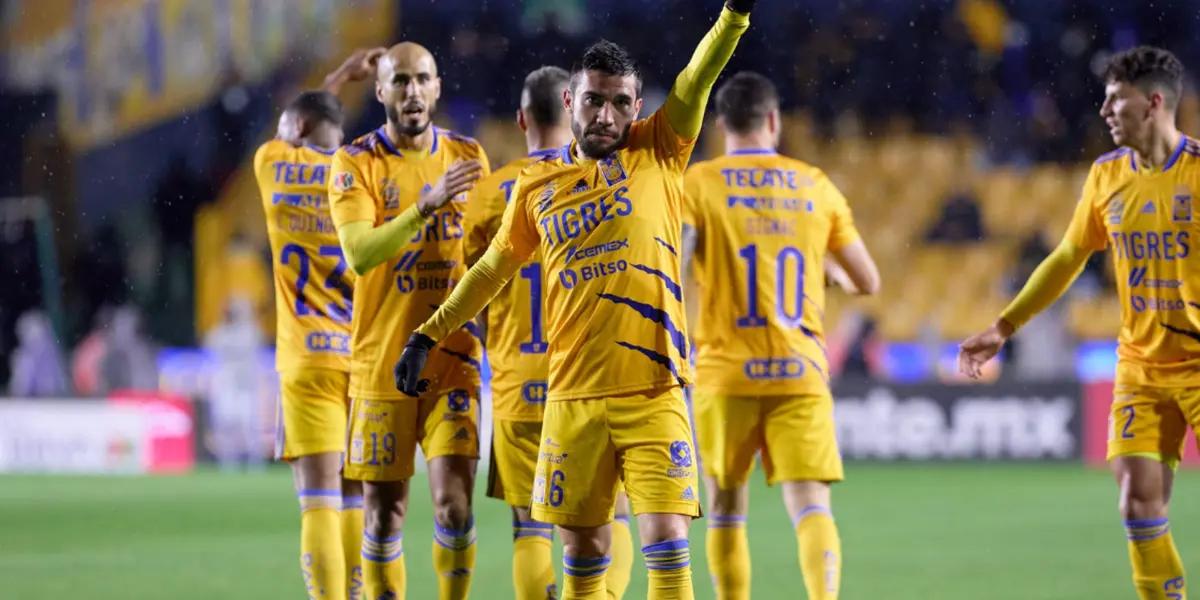 The Tigres UNAL team are celebrating together after a goal is scored.
