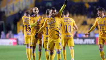 The Tigres UNAL team are celebrating together after a goal is scored.