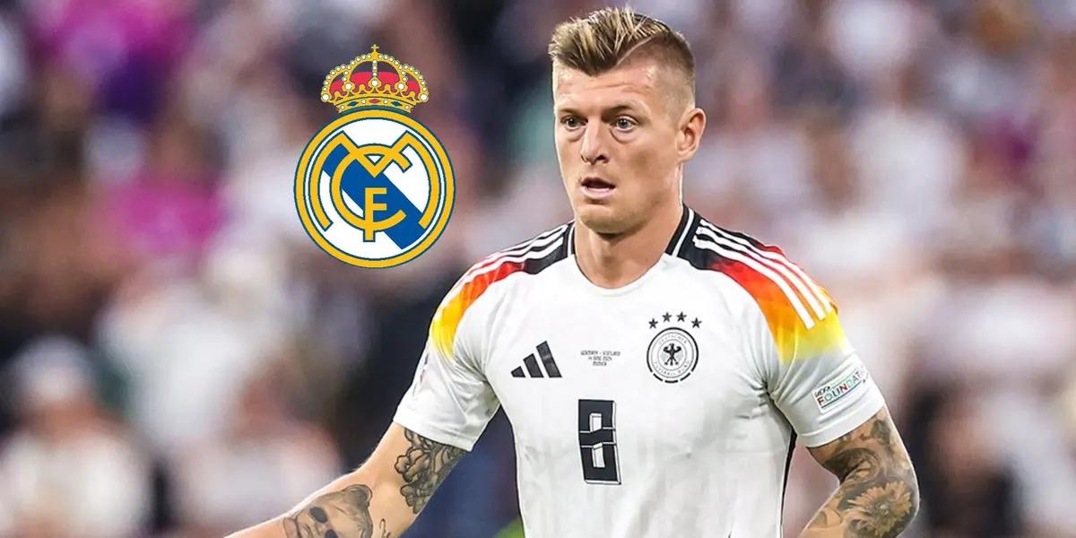 Toni Kroos looks at the pitch while wearing the Germany jersey in EURO 2024; the Real Madrid badge is next to him.