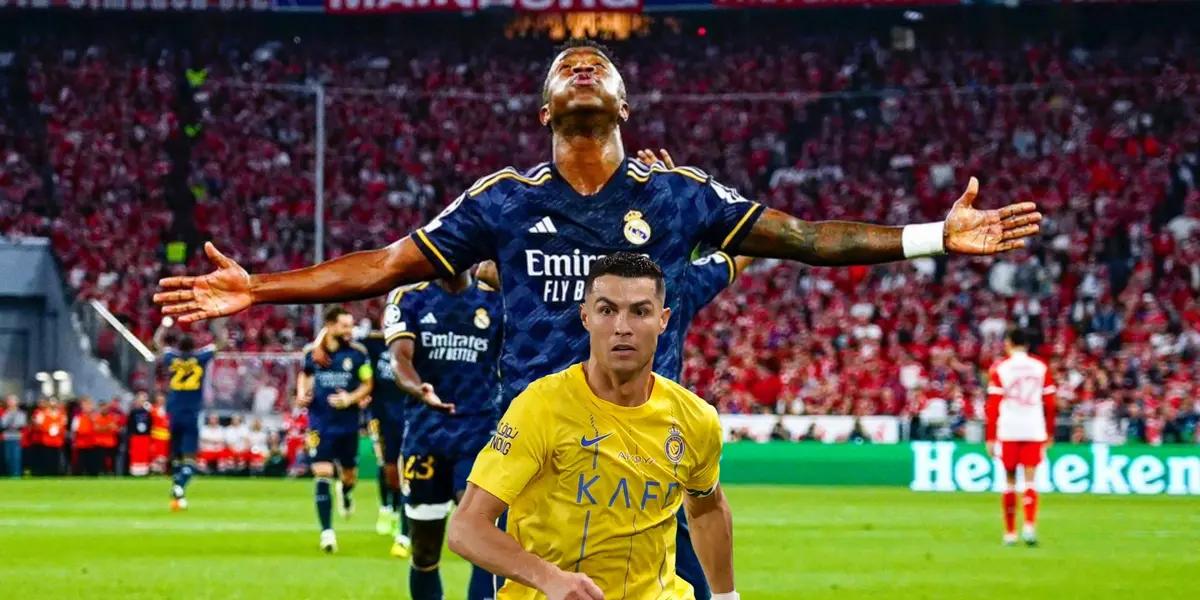 Vinicius Jr celebrates his goal fro Real Madrid with his arms out while Cristiano Ronaldo runs with Al Nassr.